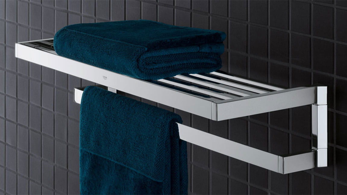 Selection cube towel rack on a black tiled wall.